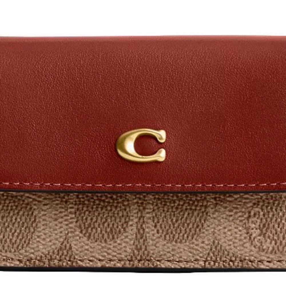 From COACH, the Mini Signature Canvas Trifold Wallet